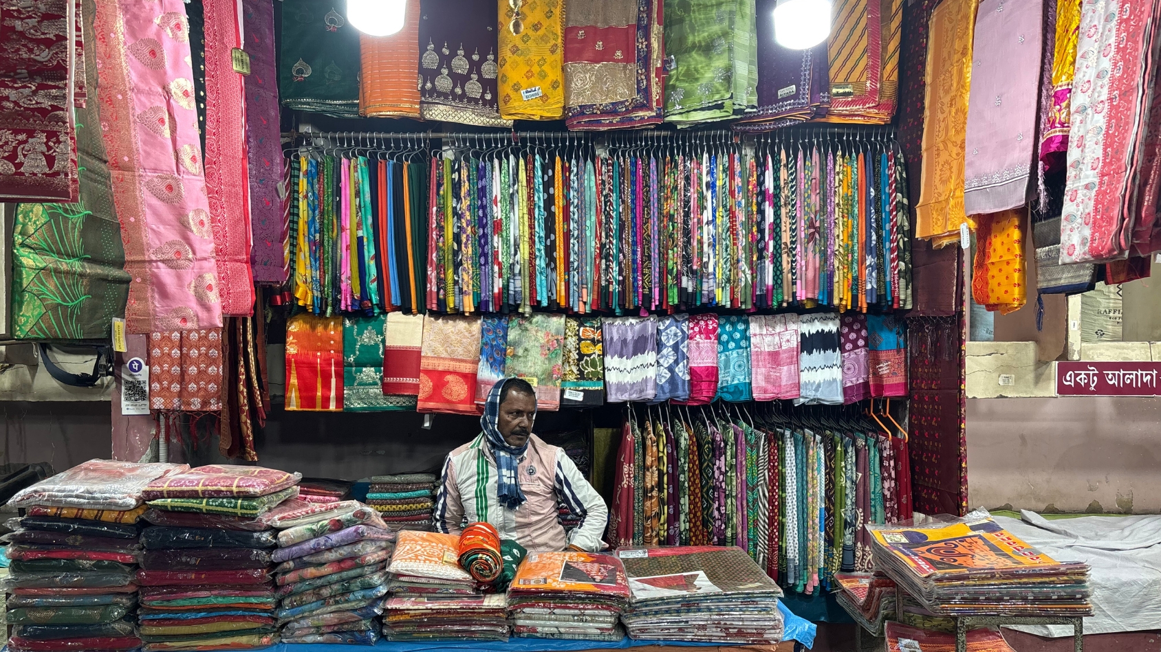 <p>A vendor selling saris, the soul of Gariahat.</p>