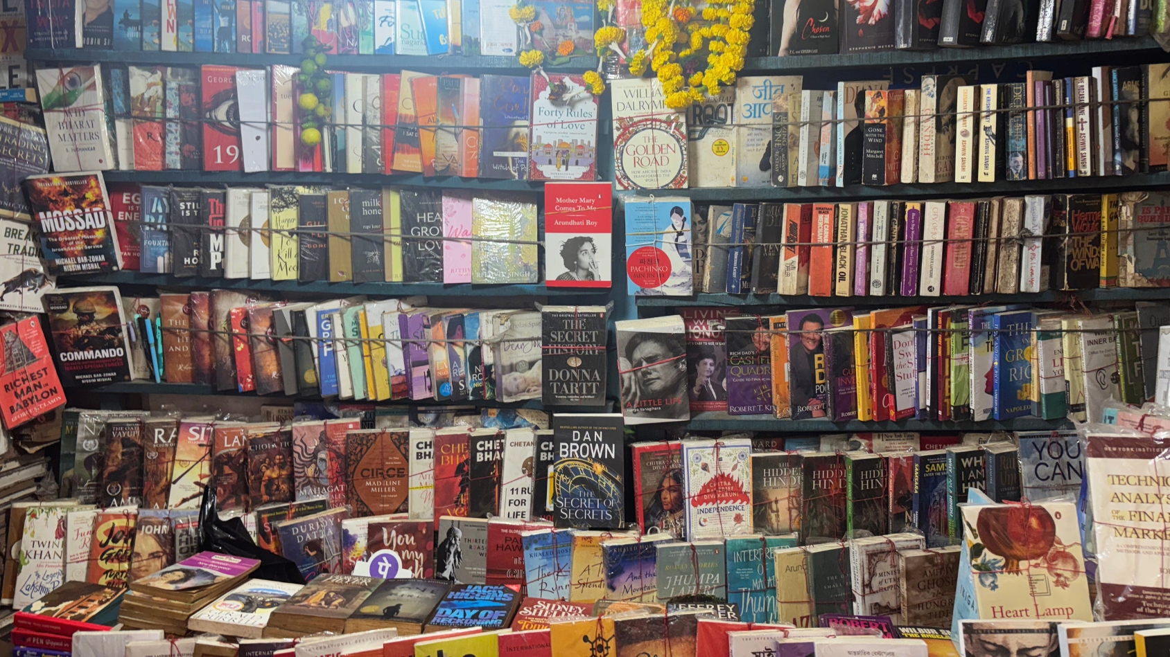 <p>A dense wall of literature ranging from global thrillers to local Bengali classics.</p>