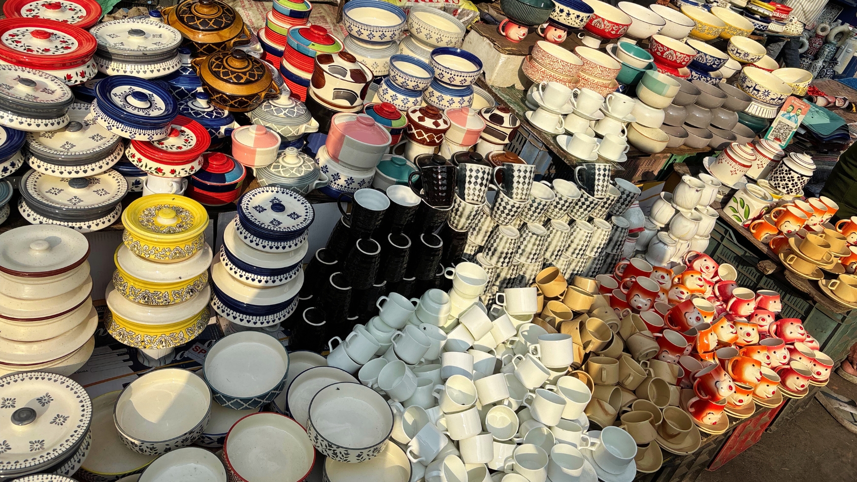 <p>A riot of ceramic cups, bowls, and casseroles spills onto the pavement.</p>