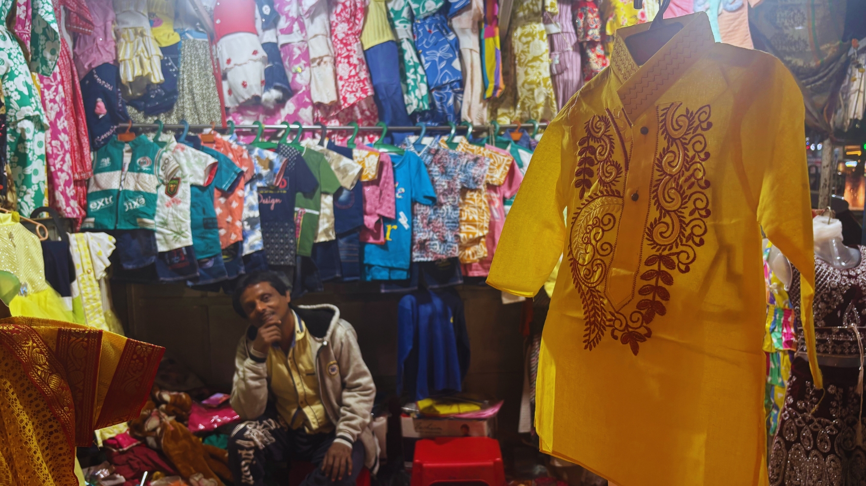 <p>Stalls spill over with children's clothing, from tiny kurtas and frocks to festive lehengas.</p>
